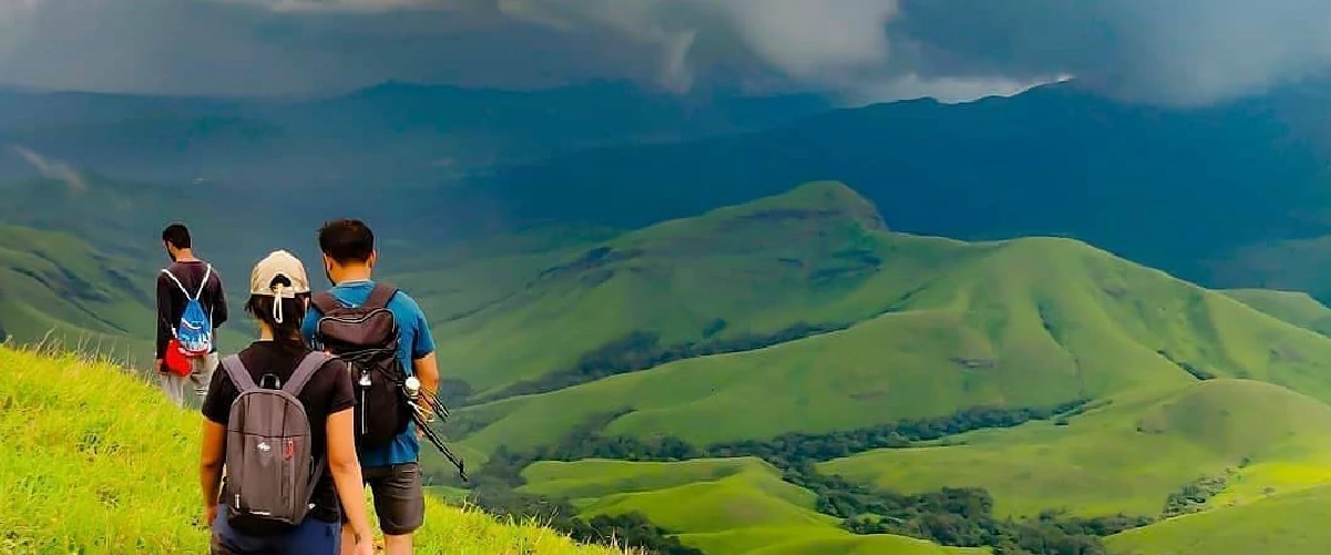 Amazing view of hill with greenery around & tourists trekking in Chikmagalur